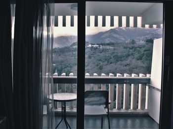Scenic view of mountains seen through glass window