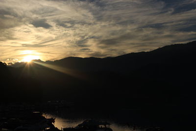 Scenic view of silhouette mountains against sky during sunset