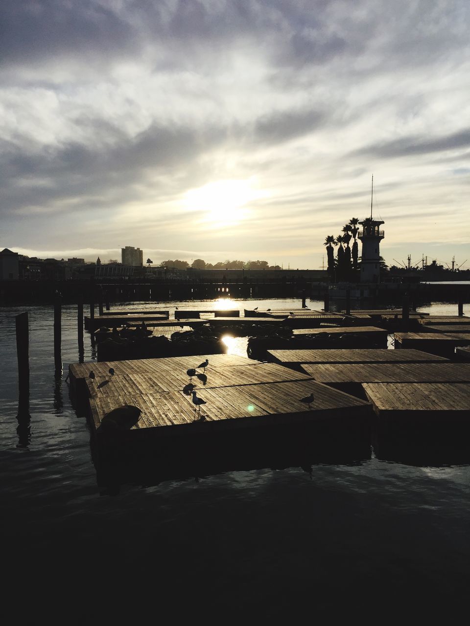 water, sunset, sky, built structure, cloud - sky, architecture, silhouette, river, building exterior, pier, sea, sun, nature, cloudy, reflection, cloud, scenics, railing, beauty in nature, sunlight