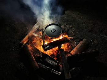 Making food in a pot on fire