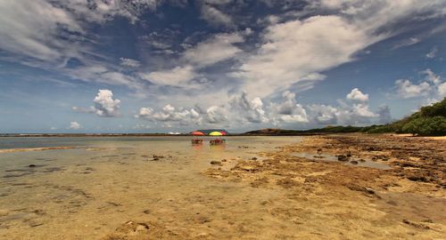 Half flooded beach umbrellas in pointe des chateaux