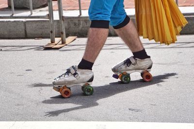 Low section of man skating on road