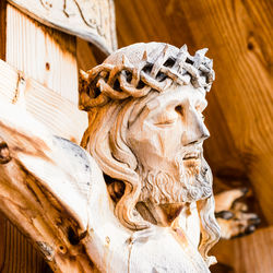 Low angle view of statue against wooden wall