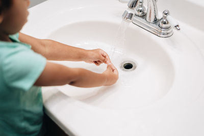 High angle view of baby feet in bathroom