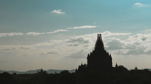 View of temple building against cloudy sky