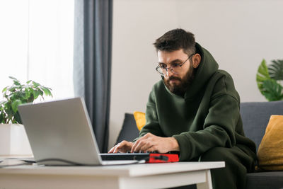 Young man using laptop at home