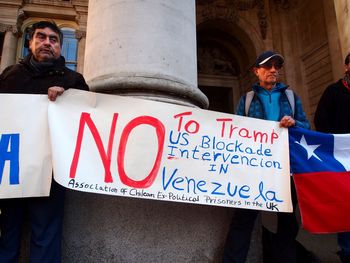 People standing by sign