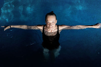 Portrait of smiling young woman in swimming pool