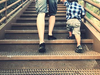 Low section of father and son on staircase