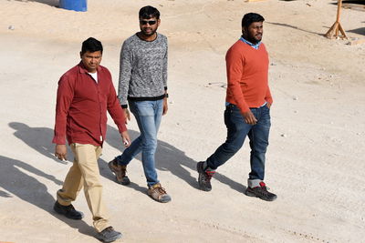 Group of people standing on sand