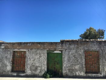 Low angle view of built structure against clear blue sky