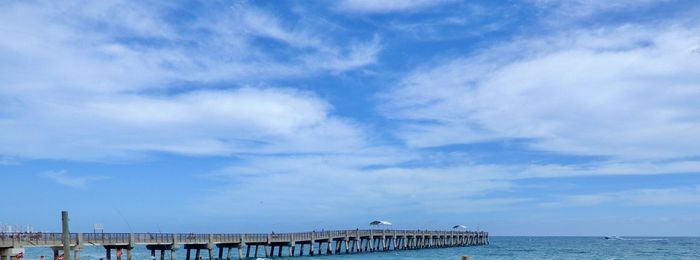Pier over sea against sky