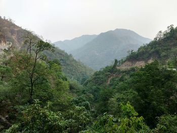 Scenic view of green mountains against sky