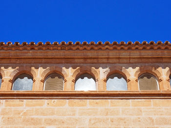 Low angle view of building against blue sky