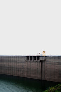 Bridge over river against clear sky
