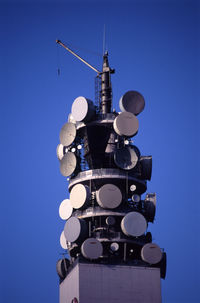 Low angle view of communications tower against clear sky