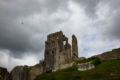 Low angle view of historic building against cloudy sky