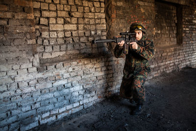 Rear view of man standing against wall