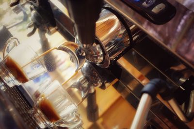 Tilt image of coffee being poured from espresso maker 
