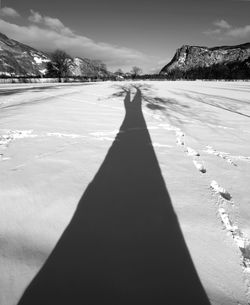 Shadow of man on snow covered landscape