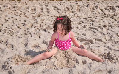 Cute young girl playing and fooling around at the beach