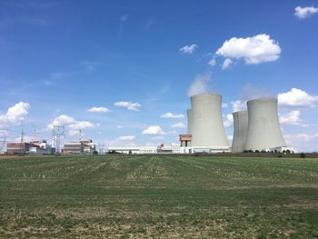 View of factory against cloudy sky