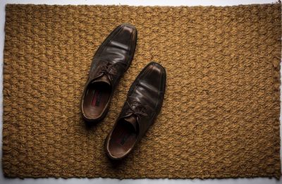 Close-up of shoes on doormat
