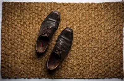 Close-up of shoes on doormat