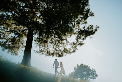 Low angle view of people walking on the hill