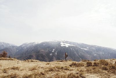 Woman hiking at monte finonchio peak against sky