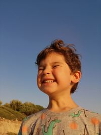 Portrait of smiling boy against clear sky