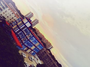 Buildings in city at sunset