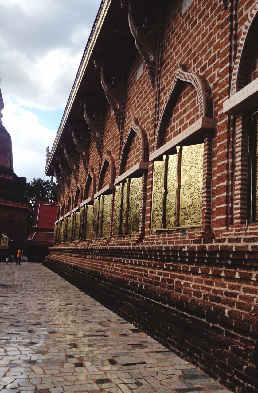 architecture, built structure, building exterior, sky, arch, railroad track, the way forward, transportation, cobblestone, outdoors, old, rail transportation, day, travel, building, diminishing perspective, cloud - sky, brick wall, incidental people, vanishing point