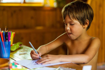 Boy drawing at home