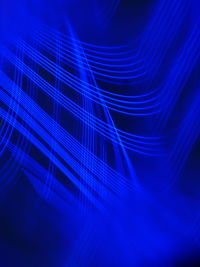 Digital composite image of illuminated light against blue background