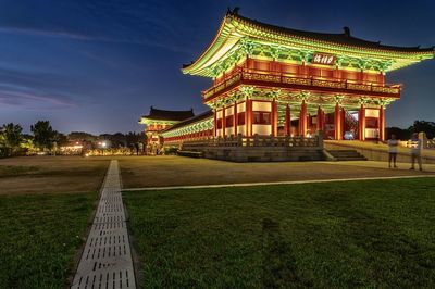 Illuminated building against sky at night