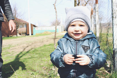 Portrait of boy wearing hat on field