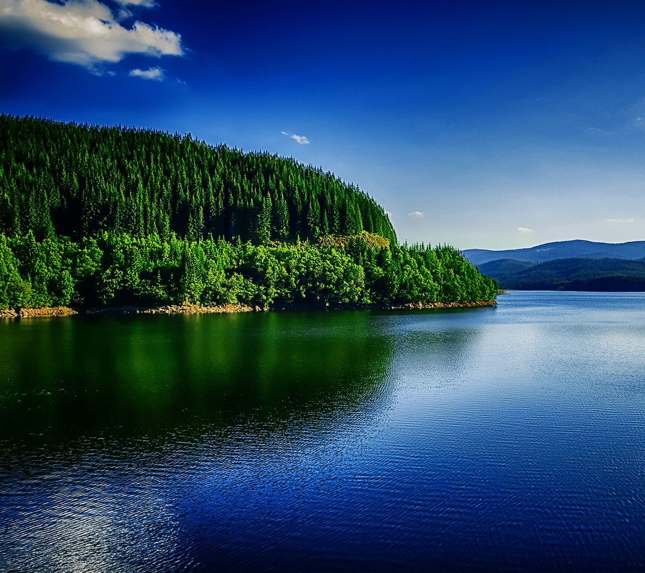 tranquil scene, water, tree, tranquility, scenics, blue, beauty in nature, nature, waterfront, lake, green color, reflection, sky, growth, idyllic, clear sky, green, day, landscape, mountain