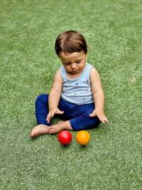 Portrait of cute girl playing with easter egg on field