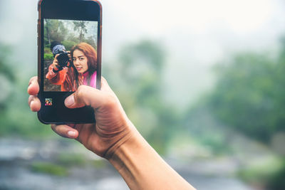 Midsection of woman photographing