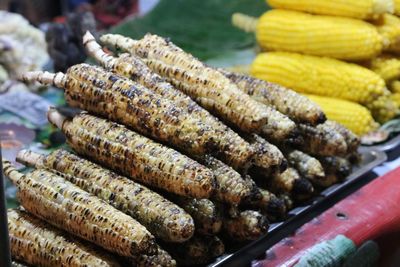 Close-up of grilled corn for sale at market