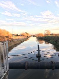 Scenic view of river against sky during sunset