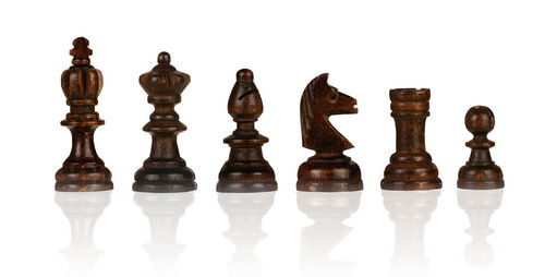 Low angle view of chess board against white background