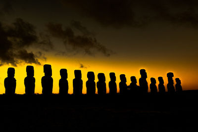 Low angle view of silhouette people against sky at dusk