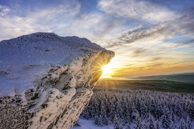 Scenic view of snow field against sky during sunset