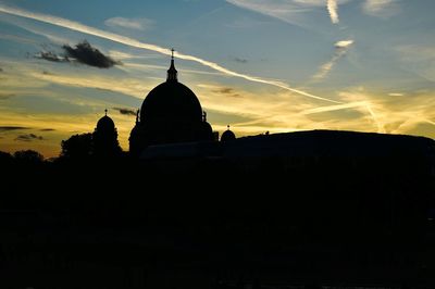 Low angle view of silhouette building against sky during sunset