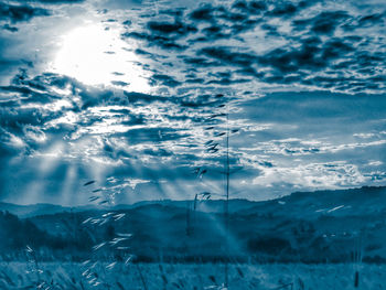 Scenic view of snow covered land against sky