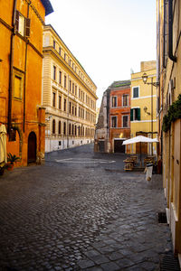 Street amidst buildings in town against sky