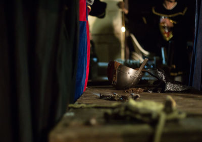 View of medieval helmet and element on wooden table