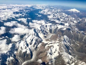 Aerial view of snowcapped mountains against sky